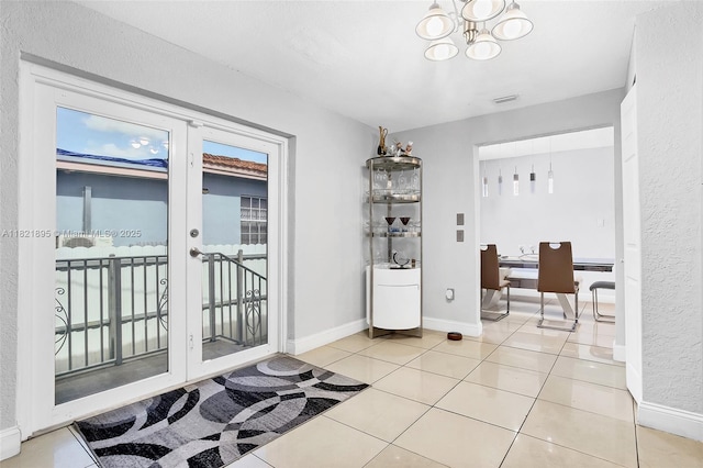 3430 NW 16th St, Miami, FL 33125 - entryway with an office area, french doors, a chandelier, and light tile patterned flooring