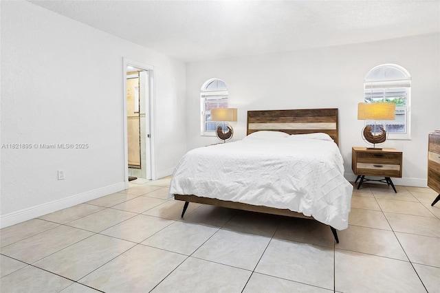 3430 NW 16th St, Miami, FL 33125 - bedroom with light tile patterned floors and ensuite bathroom