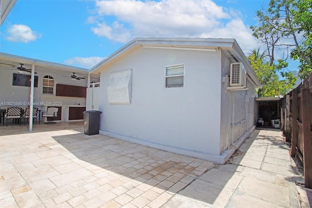 3430 NW 16th St, Miami, FL 33125 - view of side of home featuring a ceiling fan and a patio area