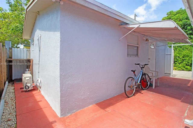 3430 NW 16th St, Miami, FL 33125 - view of side of home featuring stucco siding and a patio area