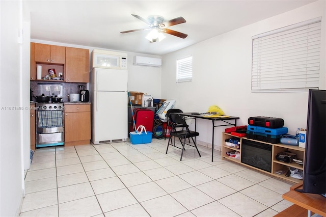 3430 NW 16th St, Miami, FL 33125 - kitchen with white appliances, a wall mounted AC, a ceiling fan, brown cabinets, and light tile patterned floors