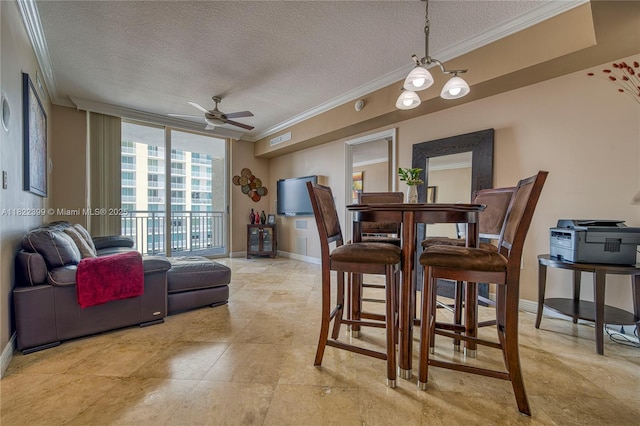 1755 E Hallandale Beach Blvd Unit 608E, Hallandale Beach, FL 33009 - dining area with ornamental molding, a textured ceiling, and ceiling fan