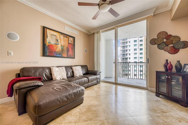 1755 E Hallandale Beach Blvd Unit 608E, Hallandale Beach, FL 33009 - living room with ornamental molding, ceiling fan, a textured ceiling, and a wall of windows
