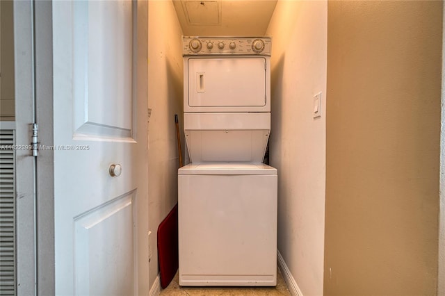 1755 E Hallandale Beach Blvd Unit 608E, Hallandale Beach, FL 33009 - washroom with stacked washer / dryer and baseboards