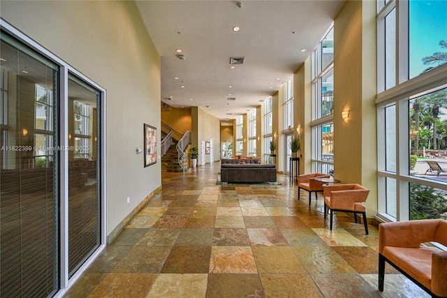 1755 E Hallandale Beach Blvd Unit 608E, Hallandale Beach, FL 33009 - lobby featuring a high ceiling, recessed lighting, and stairs