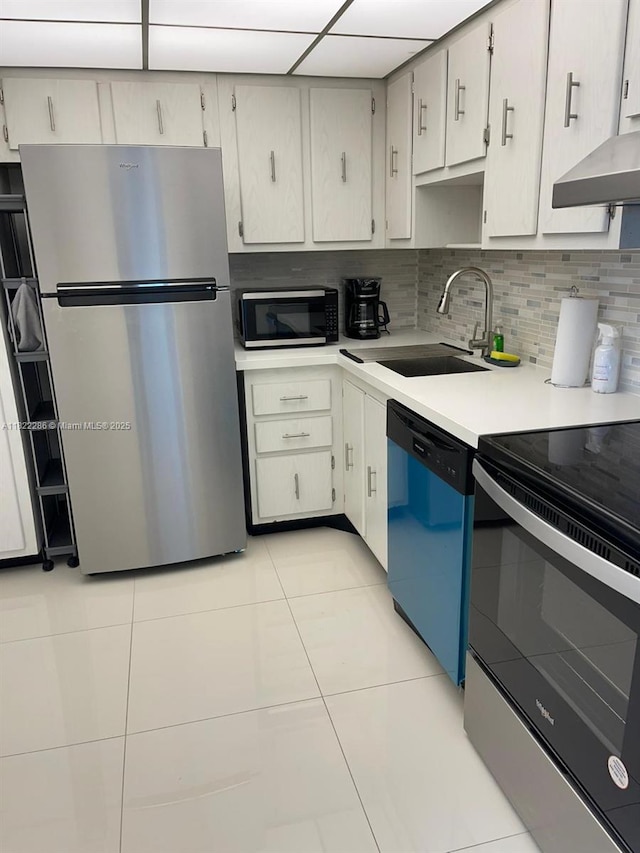20335 W Country Club Dr Unit 1701, Aventura, FL 33180 - kitchen featuring appliances with stainless steel finishes, wall chimney exhaust hood, light countertops, light tile patterned floors, and backsplash