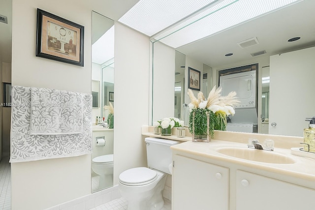 12500 SW 5th Ct Unit 112M, Pembroke Pines, FL 33027 - bathroom with stacked washer and clothes dryer, tile patterned floors, and vanity