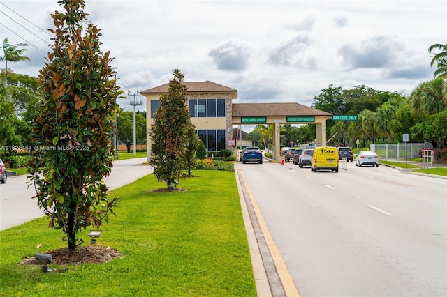 12500 SW 5th Ct Unit 112M, Pembroke Pines, FL 33027 - view of asphalt road with curbs and street lights