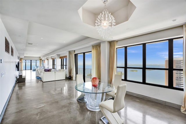 780 NE 69th St Unit T-1A, Miami, FL 33138 - dining space featuring finished concrete flooring, a water view, a chandelier, and a tray ceiling