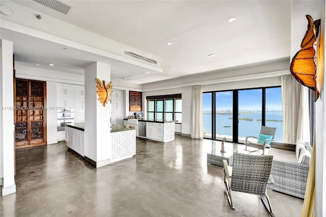 780 NE 69th St Unit T-1A, Miami, FL 33138 - living area featuring a water view, finished concrete flooring, and recessed lighting