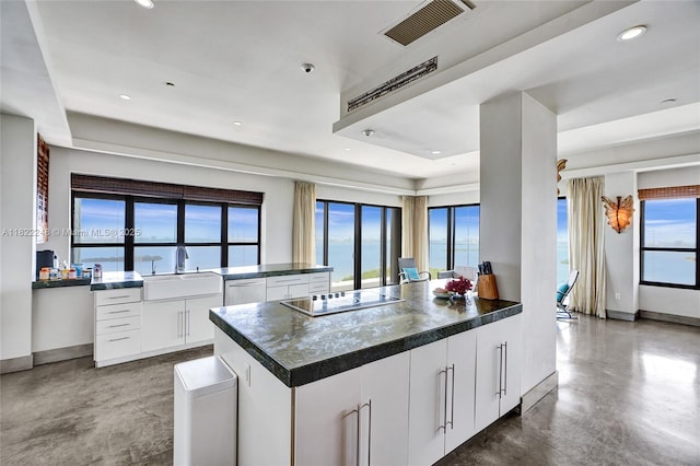 780 NE 69th St Unit T-1A, Miami, FL 33138 - kitchen with electric stovetop, dark countertops, plenty of natural light, concrete floors, and recessed lighting