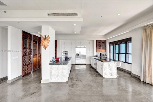 780 NE 69th St Unit T-1A, Miami, FL 33138 - kitchen with appliances with stainless steel finishes, dark countertops, finished concrete flooring, white cabinets, and recessed lighting