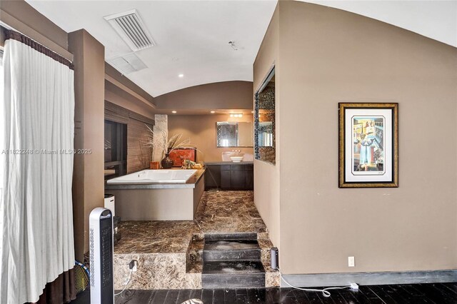 780 NE 69th St Unit T-1A, Miami, FL 33138 - bathroom featuring a freestanding bath, lofted ceiling, vanity, and recessed lighting