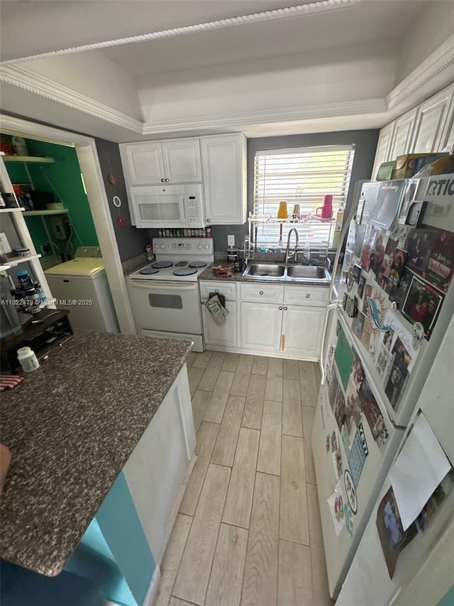 6211 SW 9th Pl, North Lauderdale, FL 33068 - kitchen featuring white appliances, washer / clothes dryer, light wood-style flooring, and white cabinetry