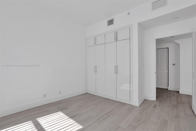 111 E Flagler St Unit 902, Miami, FL 33131 - unfurnished bedroom with a closet and light wood-style flooring