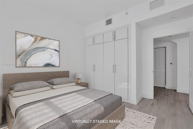 111 E Flagler St Unit 902, Miami, FL 33131 - bedroom featuring a closet and light wood finished floors