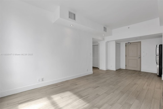 111 E Flagler St Unit 902, Miami, FL 33131 - spare room with light wood-style floors and baseboards