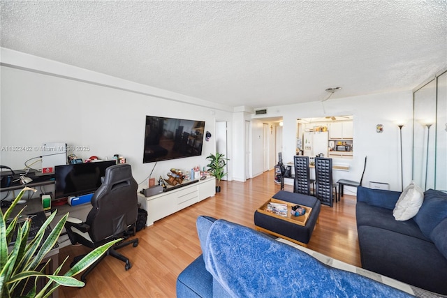 13499 Biscayne Blvd Unit 703, North Miami, FL 33181 - living room with wood finished floors, a desk, and a textured ceiling