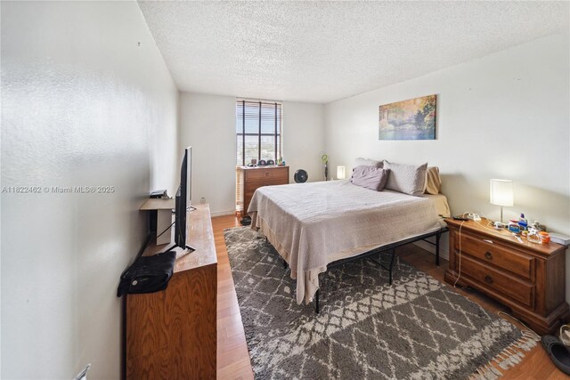 13499 Biscayne Blvd Unit 703, North Miami, FL 33181 - bedroom with a textured ceiling and wood finished floors