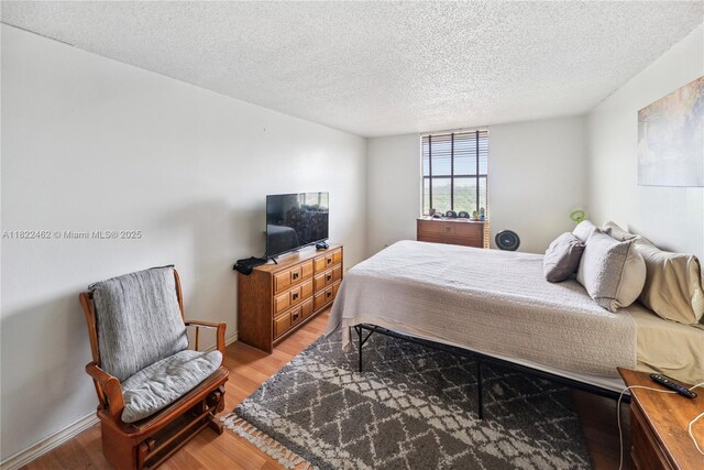 13499 Biscayne Blvd Unit 703, North Miami, FL 33181 - bedroom featuring light wood finished floors and a textured ceiling