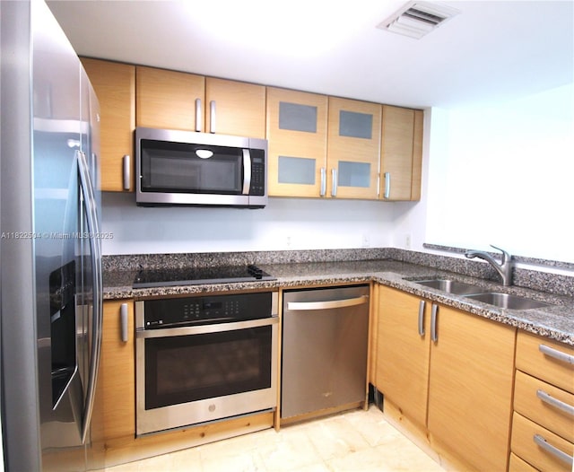 2101 Brickell Ave Unit 1711, Miami, FL 33129 - kitchen featuring appliances with stainless steel finishes, glass insert cabinets, and dark stone countertops