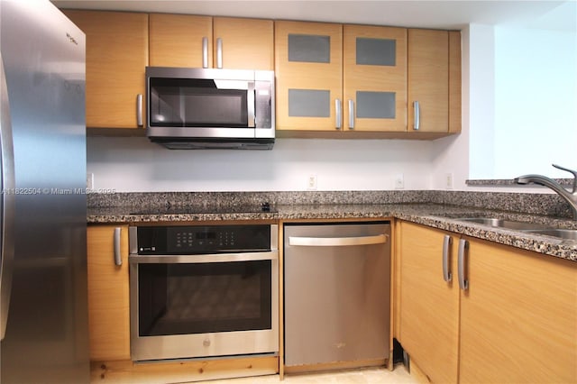 2101 Brickell Ave Unit 1711, Miami, FL 33129 - kitchen featuring appliances with stainless steel finishes, glass insert cabinets, and dark stone counters