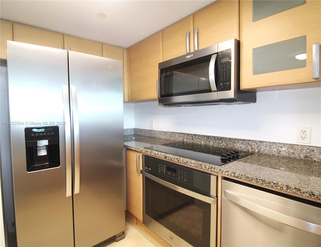 2101 Brickell Ave Unit 1711, Miami, FL 33129 - kitchen featuring appliances with stainless steel finishes and dark stone countertops