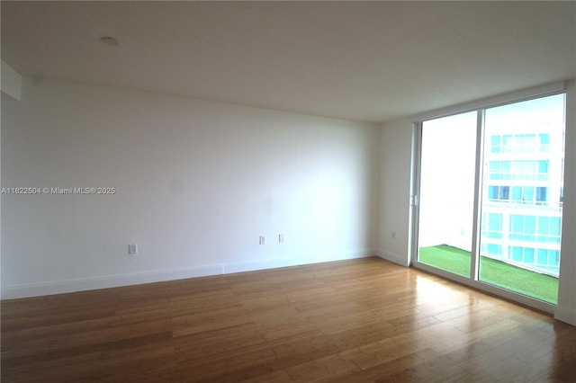 2101 Brickell Ave Unit 1711, Miami, FL 33129 - unfurnished room with wood finished floors and a wall of windows