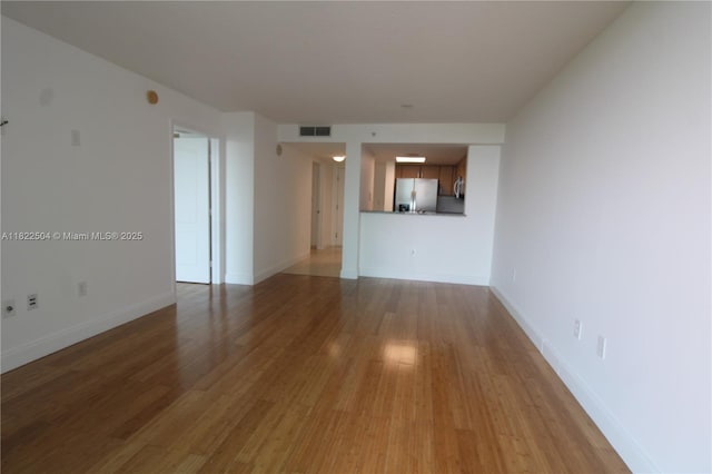 2101 Brickell Ave Unit 1711, Miami, FL 33129 - unfurnished living room with wood finished floors and baseboards