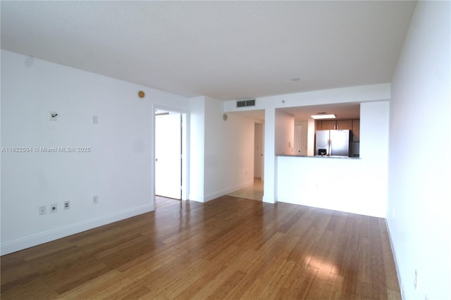 2101 Brickell Ave Unit 1711, Miami, FL 33129 - unfurnished living room featuring wood finished floors and baseboards