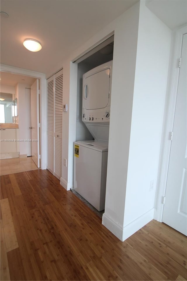 2101 Brickell Ave Unit 1711, Miami, FL 33129 - washroom featuring stacked washing machine and dryer and wood finished floors