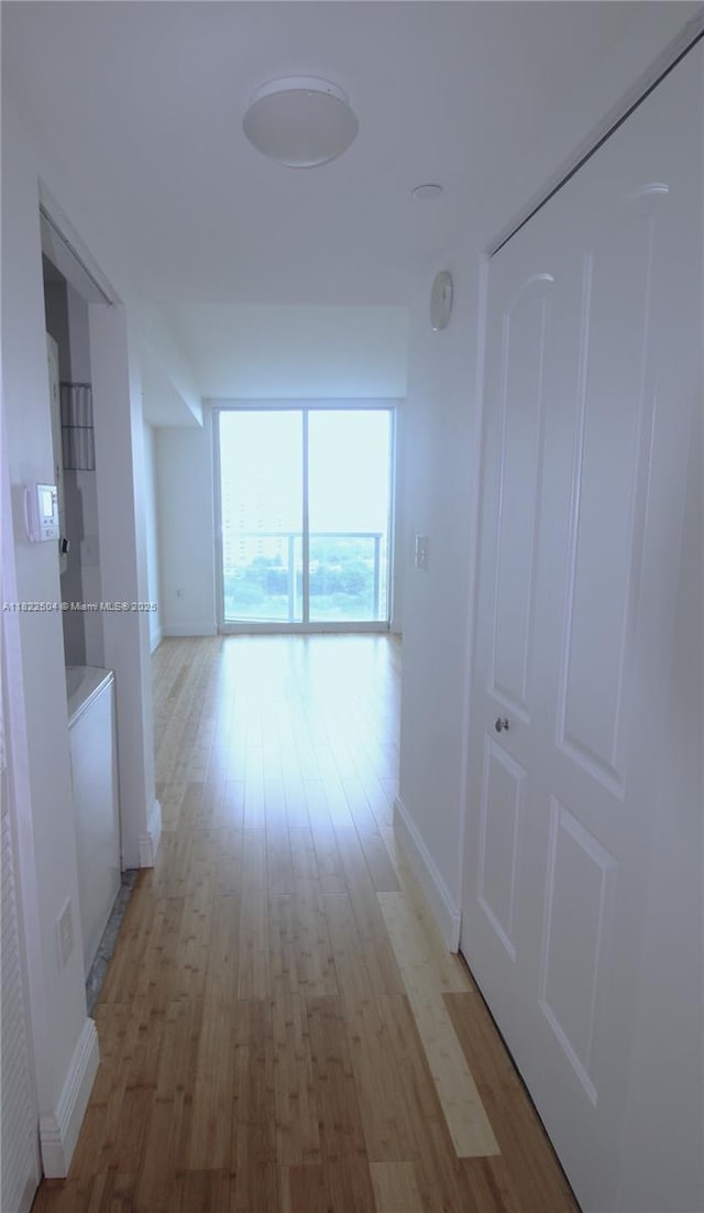 2101 Brickell Ave Unit 1711, Miami, FL 33129 - hallway featuring baseboards and light wood finished floors