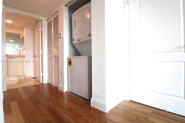 2101 Brickell Ave Unit 1711, Miami, FL 33129 - laundry area featuring estacked washer and dryer, wood finished floors, and recessed lighting
