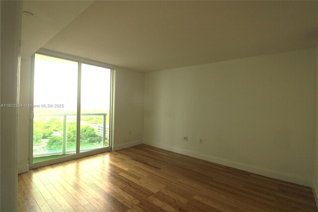 2101 Brickell Ave Unit 1711, Miami, FL 33129 - unfurnished room featuring wood finished floors and a wall of windows