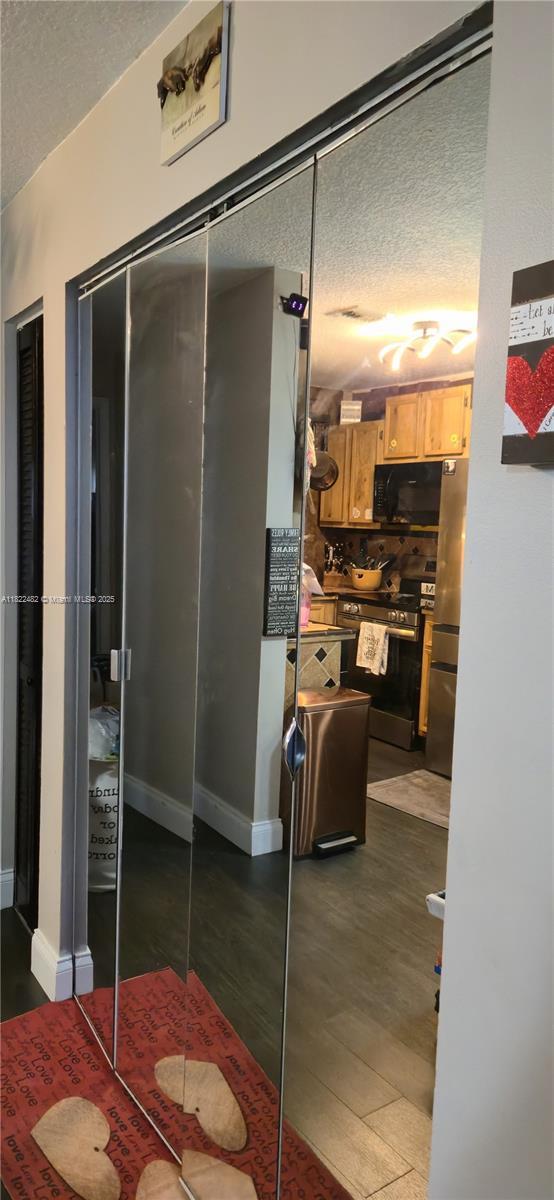 9750 NW 14th St Unit 30-5, Coral Springs, FL 33071 - bathroom with a textured ceiling and wood finished floors