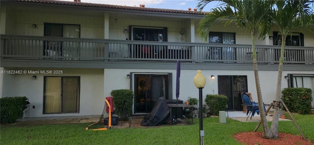9750 NW 14th St Unit 30-5, Coral Springs, FL 33071 - rear view of property with a balcony, a yard, stucco siding, and a patio