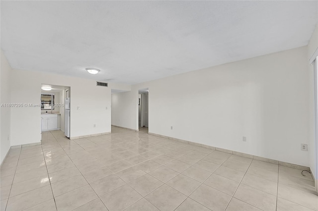650 NE 149th St Unit 406A, Miami, FL 33161 - unfurnished room with light tile patterned floors and baseboards