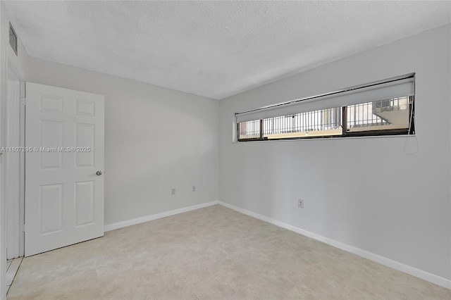 650 NE 149th St Unit 406A, Miami, FL 33161 - unfurnished room featuring a textured ceiling and baseboards