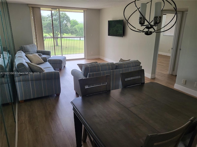 3150 W Rolling Hills Cir Unit 310, Davie, FL 33328 - living room with a chandelier, wood finished floors, and floor to ceiling windows