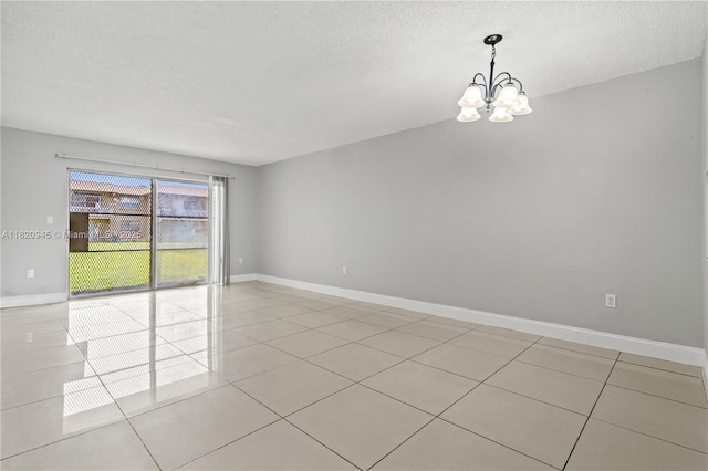 301 NW 177th St Unit 104, Miami Gardens, FL 33169 - spare room with a chandelier, light tile patterned floors, and a textured ceiling