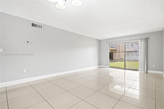 301 NW 177th St Unit 104, Miami Gardens, FL 33169 - empty room with tile patterned flooring and a textured ceiling