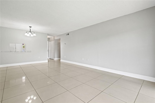 301 NW 177th St Unit 104, Miami Gardens, FL 33169 - unfurnished room featuring light tile patterned floors, a chandelier, and a textured ceiling