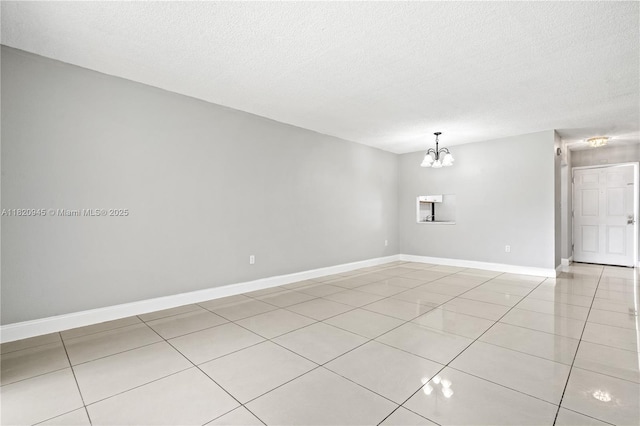 301 NW 177th St Unit 104, Miami Gardens, FL 33169 - empty room with light tile patterned floors, a chandelier, and a textured ceiling