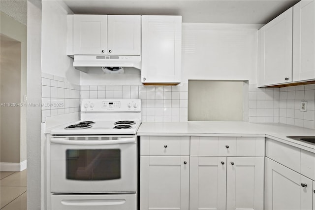 301 NW 177th St Unit 104, Miami Gardens, FL 33169 - kitchen with white electric range oven, under cabinet range hood, white cabinetry, light countertops, and decorative backsplash