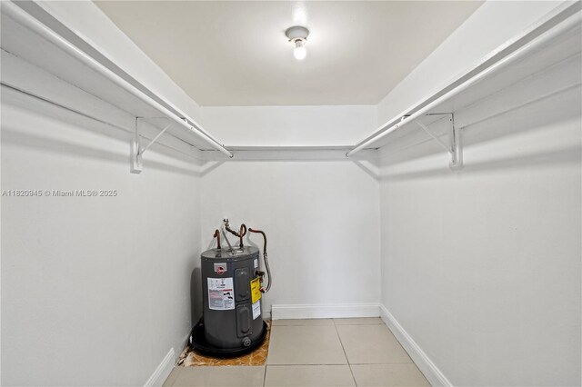 301 NW 177th St Unit 104, Miami Gardens, FL 33169 - walk in closet featuring electric water heater and tile patterned floors