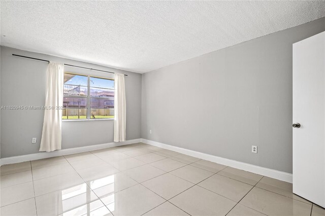 301 NW 177th St Unit 104, Miami Gardens, FL 33169 - spare room featuring a textured ceiling and light tile patterned flooring