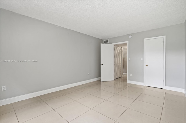 301 NW 177th St Unit 104, Miami Gardens, FL 33169 - empty room featuring light tile patterned floors and a textured ceiling