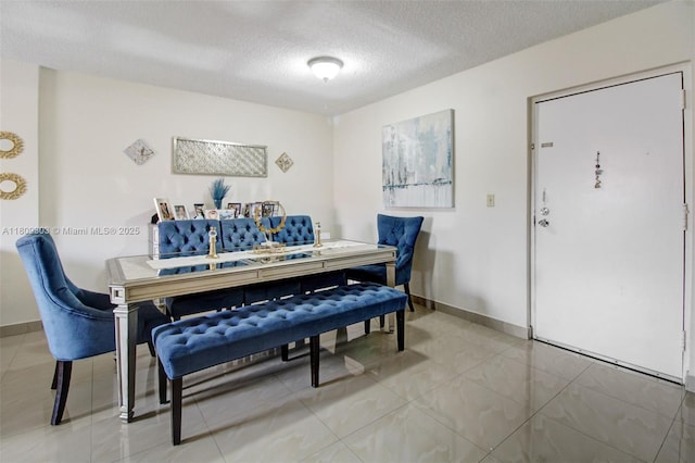 8095 NW 8th St Unit 209, Miami, FL 33126 - dining space featuring light tile patterned floors and a textured ceiling