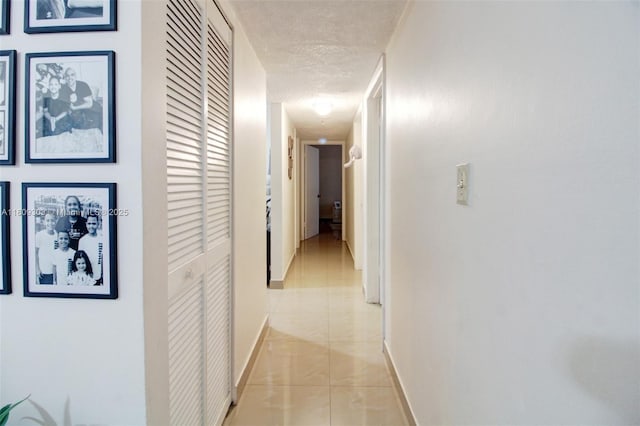 8095 NW 8th St Unit 209, Miami, FL 33126 - hallway with a textured ceiling and light tile patterned flooring