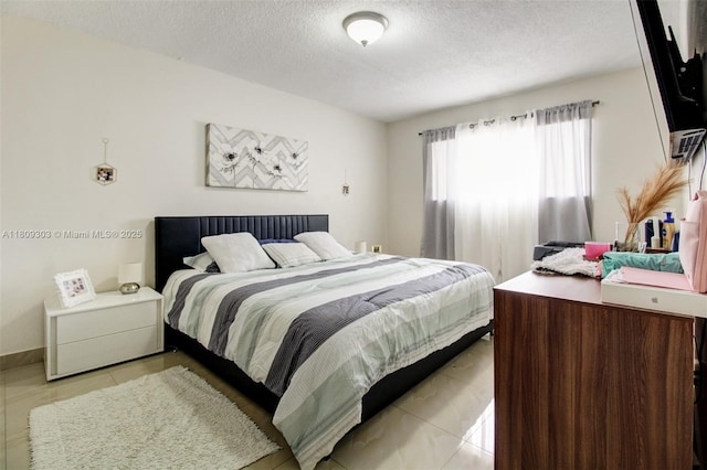 8095 NW 8th St Unit 209, Miami, FL 33126 - bedroom featuring a textured ceiling and light tile patterned floors
